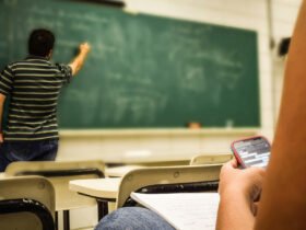 Teacher writing on a chalkboard