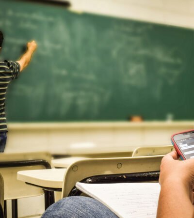 Teacher writing on a chalkboard