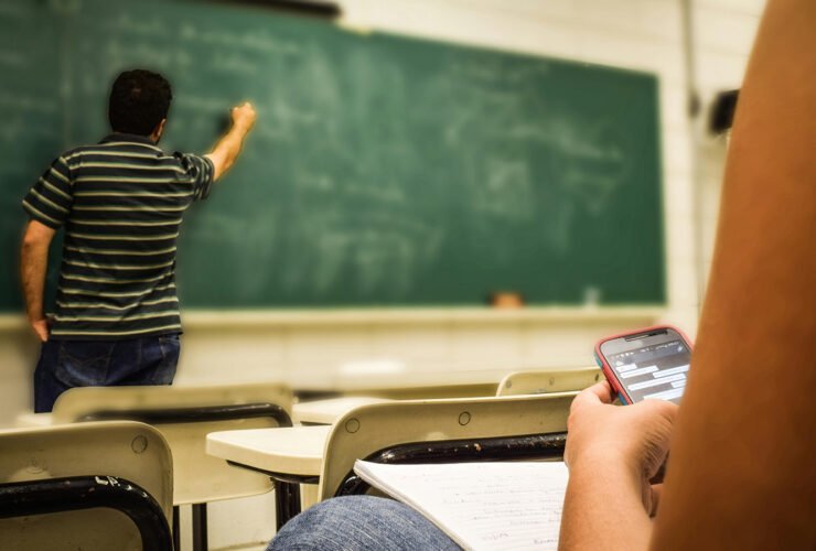 Teacher writing on a chalkboard